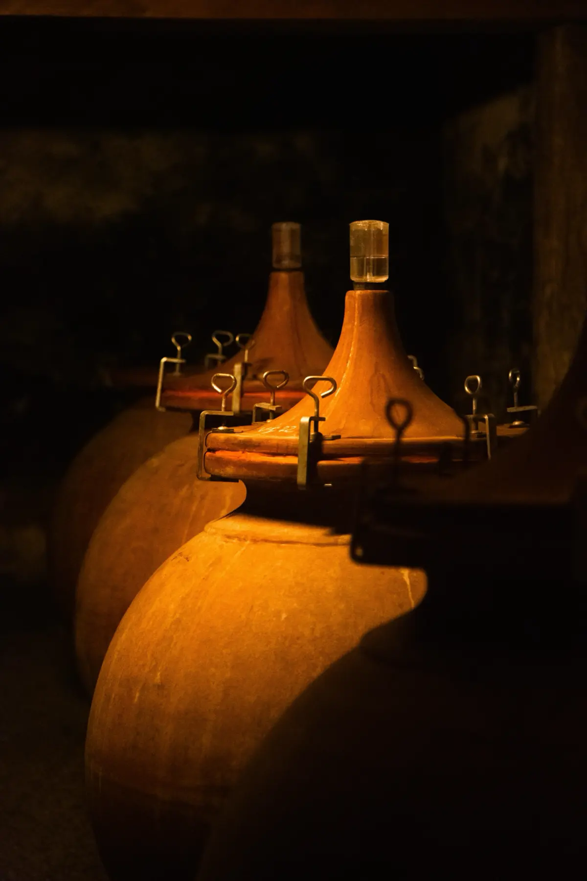 Terracotta jars in the dim cellar