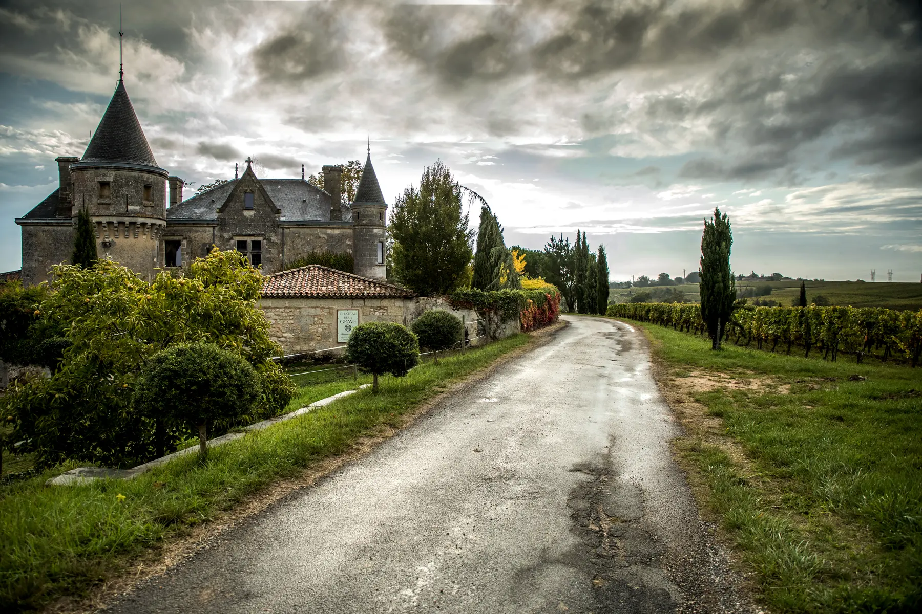 Château de la Grave beside a gravel road through the vines