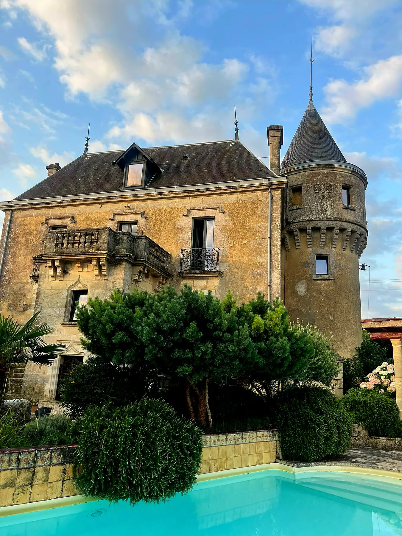 Stone wing of the château with climbing vines