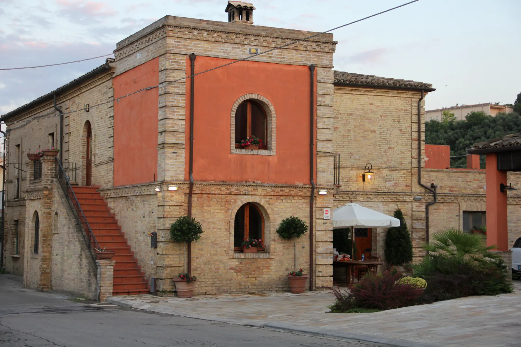 The stone Pasetti estate building and its brick staircase