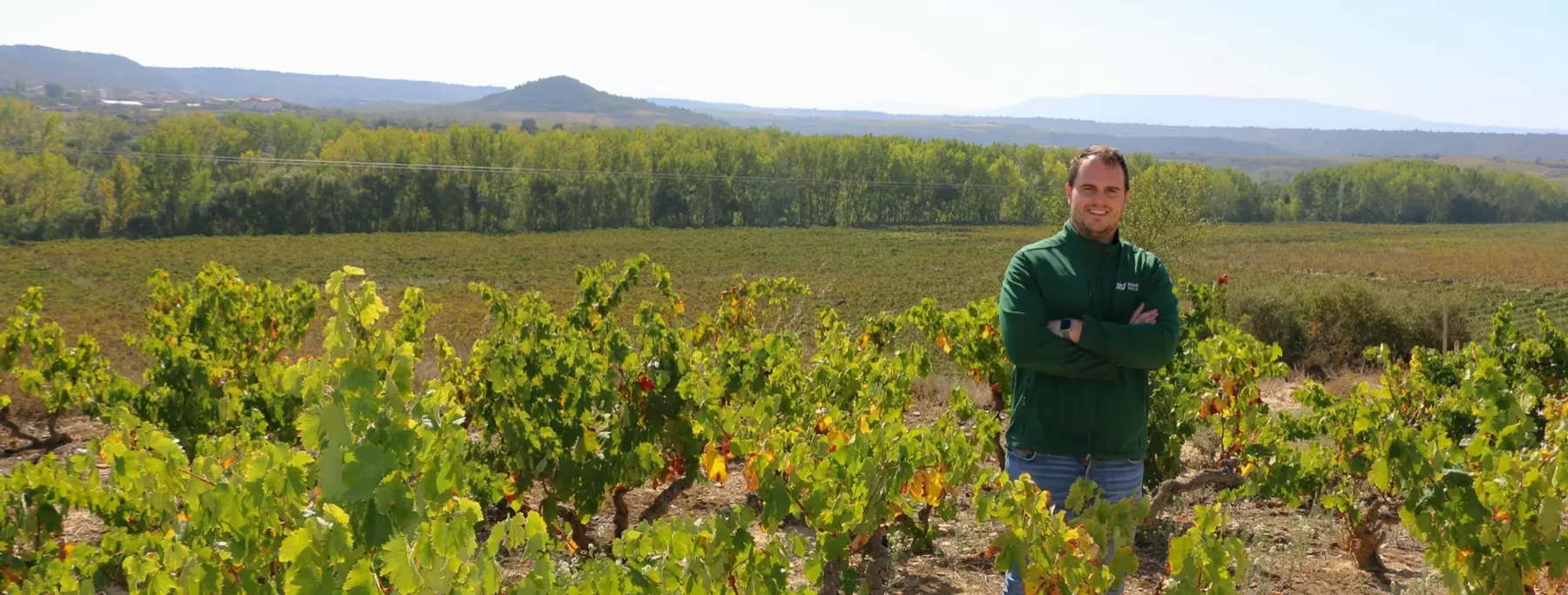 A viticultor standing among old vines in Lapuebla de Labarca